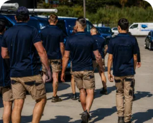Plumbers walking to their service vans on a Stanhope Gardens job